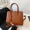 Elegant brown trapezoid tote bag with H-charm and detachable shoulder strap - Brown