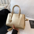 Elegant gold metallic handbag with circular handles and a detachable shoulder strap - Champagne Gold