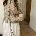 Detail view of mini faux fur crossbody bag with leather flap worn with knit sweater - Apricot