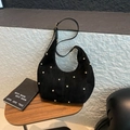 Detail of black suede hobo bag with gold rivet studs and adjustable shoulder strap - Black
