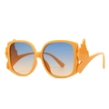 Modern oversized bright orange sunglasses with distinctive wing-shaped frames and gradient lenses - Orange Frame Blue Tea Gradient