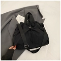 Detail of waterproof black nylon tote bag with drawstring closure and adjustable strap - Black