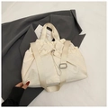 Detailed close-up of cream nylon drawstring tote bag with metallic lock and wide shoulder strap - Off White