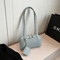 Minimalist light blue leather baguette bag with matching mini pouch and slim straps - Blue