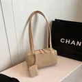 Chic beige baguette underarm bag in matte leather with a mini coin purse charm - Khaki