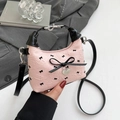 Pink floral crossbody bag with black bow print and heart-shaped metal charm - Pink