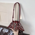 Fashionable wine red studded bucket bag with silver eyelets and pearl chain strap - Burgundy