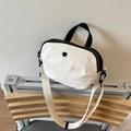 Lightweight white nylon crossbody bag with black handles and adjustable shoulder strap - White