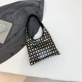 Black hobo underarm bag with silver metallic rivets and minimalist modern aesthetic - Black