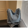Detail of vintage blue denim bag with metallic rivets and chain shoulder strap - Light Blue