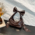Dark brown patent leather shoulder bag with a large bow handle and silver rivet details - Brown