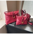 Detail of red PU leather bag set with gold U-shaped buckle and woven strap accents - Large / Red