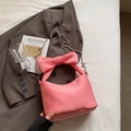 Pink nylon pillow crossbody bag with large bow handle and silver chain strap - Pink