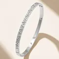 Macro detail of silver stainless steel bangle with triangular-cut crystals in a row - Silver