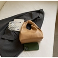 Minimalist khaki PU leather handbag shown on a grey suit with aesthetic lifestyle props - Khaki