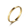 Detail of gold stainless steel bracelet featuring Greek key meander patterns and side buckle - Gold