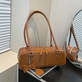 Brown leather baguette shoulder bag with fashion metal logo and heart bow charm - Brown
