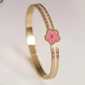 Macro shot of gold stainless steel bangle with pink enamel band and floral motif - 6mm Width / Pink