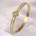 Detailed macro view of a gold-plated clover bangle with white enamel inlay accents - White Clover Bangle (40甲-C-1) / White