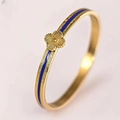 Close-up of gold stainless steel bangle with blue enamel and four-leaf clover detail - Blue Clover Bangle (40甲-B-10) / Blue