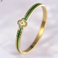 Detailed close-up of a gold-plated bangle featuring green enamel inlay and clover charm - Green Clover Bangle (40甲-B-8) / Green