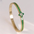 Detailed view of gold clover bracelet with green enamel and sparkling crystals - Green Clover With Diamonds Style