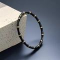 Detail of bamboo joint bracelet featuring black enamel and gold metal on a stone pedestal - Black Bamboo Bangle (32-D-5)
