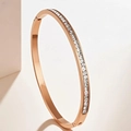 Detail of rose gold bangle with single row of square diamonds and hinge clasp - Rose Gold