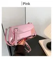 Close-up of pink glossy mirror-finish shoulder bag with metallic synthetic leather texture - Pink