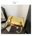 Detail shot of metallic gold patent leather baguette bag with adjustable strap and buckle - Gold