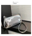 Detailed shot of a silver patent leather baguette bag with shiny metallic finish and strap - Silver