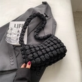 Minimalist black pleated cloud tote bag with puffy texture on gray blazer background - Black