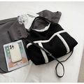 Detail of black suede tote bag with white sherpa trim and adjustable shoulder strap - Shoulder Bag Set / Black