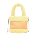 Faux shearling bucket bag in light yellow with plush texture and golden chain strap - Yellow