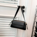 Minimalist black leather baguette bag with sleek shoulder strap and gold-tone hardware detail - Black