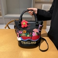 Black bucket bag with Thai-style colorful embroidery patches and a shoulder strap - Black