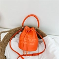 Orange drawstring bucket bag in pebble leather featuring top handle and logo print - Orange