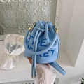 Close-up of light blue leather bucket bag with drawstrings and golden hardware - Light Blue