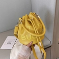 Yellow bucket bag with THE BUCKET print in litchi grain leather and gold hardware - Yellow
