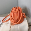 Vibrant orange pebble leather drawstring bucket bag with elegant love letter printing - Orange