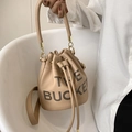 Khaki pebbled leather bucket bag featuring The Bucket lettering and drawstring closure - Khaki