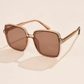 Detailed close-up of brown oversized square sunglasses with transparent resin frames - Champagne