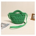 Detail of a bright green hand-crocheted woven bag with thick cotton rope and shoulder strap - Green