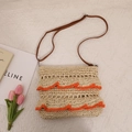 Beige straw crossbody bag featuring vibrant orange ruffles and brown leather strap - Orange Ruffle