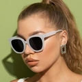 Close-up of stylish white matte sunglasses and silver earrings on a fashion model - White Frame Gray Lens