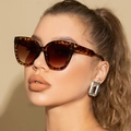 Close-up of leopard cat eye sunglasses with brown lenses and silver rectangle earrings - Leopard Tortoise Frame Gradient Tea