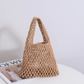 Handwoven khaki cotton mesh tote bag for summer beach fashion on a minimalist white table - Coffee