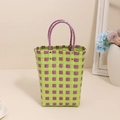 Green and purple checkered plastic woven handbag with durable round handles and metal rivets - Purple
