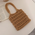 Handwoven caramel hollow cotton crochet beach tote bag with braided handles on a table - Coffee