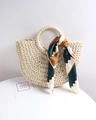 Close-up of semi-circle straw tote bag with rigid round handle and decorative silk scarf - Off-white + Green Wave Striped Scarf